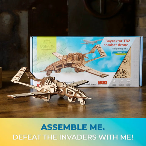 Bayraktar TB2 Combat Drone Wooden Model Kit With Movable Rudders, Wing Ailerons, Moving Camera And Underwing Missiles, Realistic 3D Puzzle For Adults, Durable Handcrafted Aircraft Building Toy For Collectors And Tinkerers. Wooden drone model on table, box behind