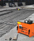 Heavy Duty Electric Rebar Bender With A Beastly 3000W Motor That Knocks Out Steel Rods Fast Offers Hassle Free Zero To One Eighty Angle Adjustments And A Smooth Foot Pedal For Boss Level Jobsite Efficiency on construction site with steel reinforcement grid.