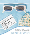 Freshends lens cleaning wipes; front view shows two items: white-frame sunglasses and wipe card on blue fabric
