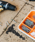 Vintage Style Black Zinc Alloy Tee Door Hinges 2 Pack Slip Joint Lift Off next to screws and drill on a work surface