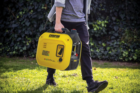 Person carrying a 2500 Watt Dual Fuel Portable Inverter Generator With Quiet Technology And CO Shield Gas Or Propane Powered