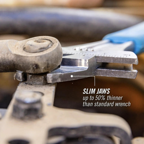Slim Jaw Adjustable Wrench 8 Inch with Extra Wide Mouth gripping bolt in tight spot, showing Code Blue finish in use for repairs.