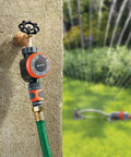 Concrete wall-mounted Easy To Use Mechanical Water Timer With Flow Control For Sprinklers And Drip Irrigation next to green lawn