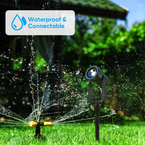 Color Changing Landscape Lights Multicolor Spotlight Set With Remote For Outdoor Garden Yard Lawn Tree Pool Use 5 Pack IP65 Waterproof Transformer Included beside a garden sprinkler.