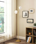 Mid Century Modern Floor Lamp With Built In LED Gold Globe, Stepless Pedal Dimmer, Two Frosted Glass Shades in a living room corner