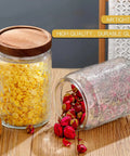 Airtight 24 oz glass storage jar with bamboo lid on kitchen counter, one jar filled with corn, another with dried roses.
