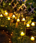 Sun Powered Mushroom String Lights, 20 LED Over 32.8 Feet Of Outdoor Waterproof Pathway Lighting illuminating a garden fence
