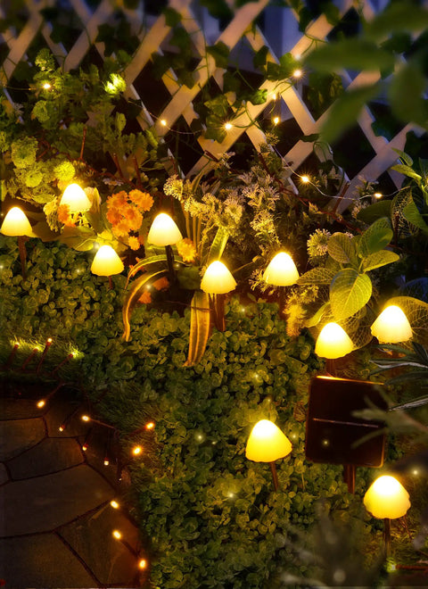 Sun Powered Mushroom String Lights, 20 LED Over 32.8 Feet Of Outdoor Waterproof Pathway Lighting illuminating a garden fence
