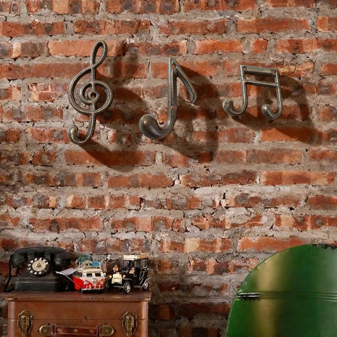 3 Piece Music Note Cast Iron Wall Hooks For Hanging Your Coats Hats And Totes Pretty Sweet Decorative Heavy Duty Coat Rack with a rustic brick wall.
