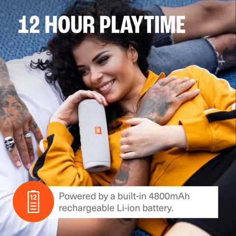 Woman holding Flip 5 Dope Waterproof Portable Bluetooth Speaker With 12 Hours Of Playtime, IPX7 Waterproof, in gray