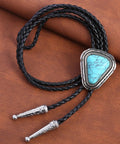 Hand Braided From Premium Genuine Leather This Adjustable Turquoise Bolo Tie on brown background with metal tips