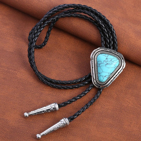 Hand Braided From Premium Genuine Leather This Adjustable Turquoise Bolo Tie on brown background with metal tips