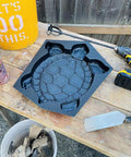 DIY Concrete Stepping Stones Mold Kit With Turtle Statue Texture For Garden Pathway on a workbench with tools