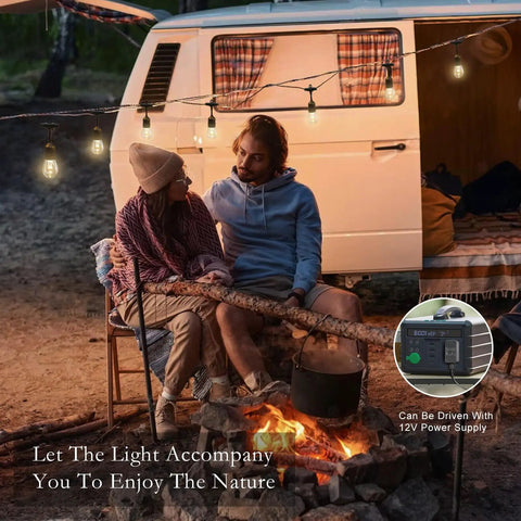 Couple enjoying campfire under Safe 12V LED Outdoor String Lights For Patios And Pergolas 96 Ft Total With 30 Shatterproof Bulbs