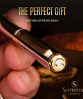 Luxurious Silver Chrome Ballpoint Pen With Real Gold Plating And Schmidt Black Refill close-up in hand with mother-of-pearl inlay.