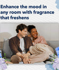 Couple relaxing in living room with PlugIns Air Freshener Starter Kit in Clean Linen scent enhancing mood and freshness.