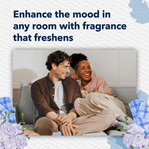 Couple relaxing in living room with PlugIns Air Freshener Starter Kit in Clean Linen scent enhancing mood and freshness.