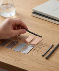 Person holding graphite rod from Metal Electrodes Kit For Basic Electricity Science Demos With Zinc Sheets Copper Plates Iron Anode Sheet