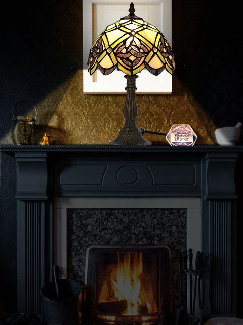 Irish Celtic Tiffany Style Stained Glass Table Lamp With 17500 Lumen Light on a mantel over a cozy fireplace.