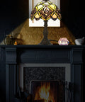 Tiffany Hummingbird Stained Glass Table Lamp With 16 Inch Wide Shade And 24 Inch Tall Body Antique Zinc Base in dim living room.