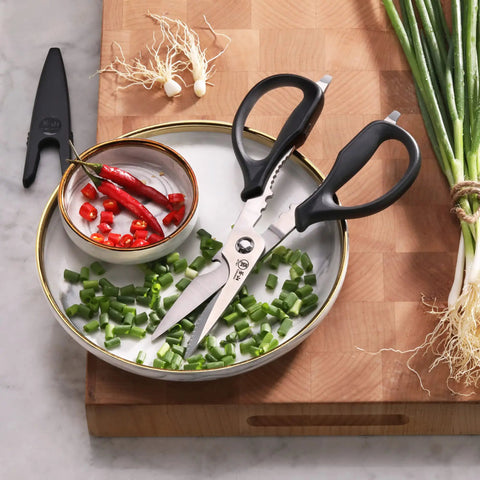Heavy-Duty 9-Inch Come-Apart Kitchen Shears With Guard For Everyday Food Prep No-Nonsense Tough-As-Nails Scissors That Slice Poultry, Herbs, Veggies, Packaging And Twine, Easy Cleaning Break-Apart Blades For Quick Cleanup on cutting board with scallions and chilies