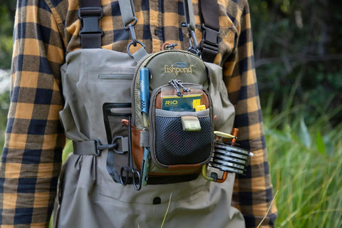 Person wearing Vertical Fly Fishing Chest Pack with Zippered Main Compartment and Interior Pocket, low profile in tidal blue on chest.