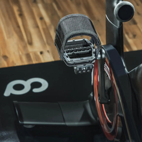 Strap In Platform Pedals For Peloton Bikes And Regular Shoes With Extra Wide Platform And Anti Slip Grips on wooden floor