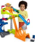 Toddler playing with Hot Wheels Spiral Stunt Speedway Race Track Playset With Two Cars For Toddlers 18 Months And Up