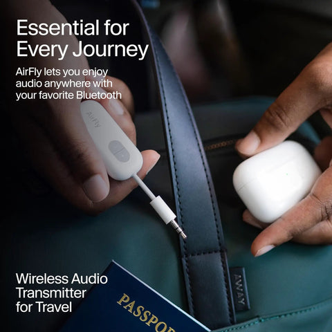 Person holding Wireless Bluetooth Audio Transmitter For AirPods And Headphones With 20 Plus Hour Battery next to travel bag