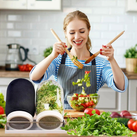 Woman using Two Pack 32 Oz Wide Mouth Sprouting Jars Kit With Stainless Steel Sprouter Lids Stand Blackout Sleeves And Drain Tray