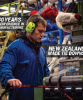 Worker inspecting rear transom boat trailer straps ratchet tie downs in a New Zealand manufacturing facility