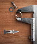 Heavy Duty Stainless Steel Spring Plunger Pin With Knurled Grip And Quick Release Pull Ring on a wood surface with tools.