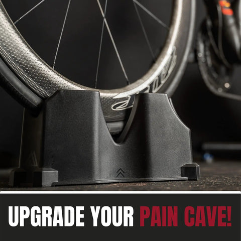 Front Wheel Riser Block For Indoor Bike Trainers With Three Height Levels supporting a bike wheel; text 'Upgrade Your Pain Cave' visible.