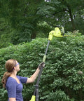 Person using Multi Angle Telescoping Electric Hedge Trimmer With Convertible Pole To Handheld 19 Inch Blade in garden