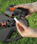 Hands showing part of ZoomMaxx Adjustable Oscillating Sprinkler On Metal Step Spike For Even Watering Of Large Lawns Up To 2300 Sq Ft