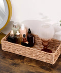 Must Have Woven Tissue Holder And Toilet Paper Organizer Box with iron frame displaying bottles and lamp on wooden surface.