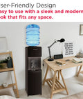 Top Loading Water Cooler Dispenser With Hot And Cold Water And Child Safety Lock Freestanding Slim Space Saving Design For Home Or Office No Fuss 3 Or 5 Gallon Bottles Black next to wooden desk in modern office