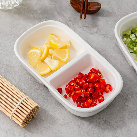 Set Of Two Divided Ceramic Dip Bowls With Stainless Steel Rims Zero Fuss Layout For Soy Sauce Vinaigrettes And Spice Mixes with lemon and chili.