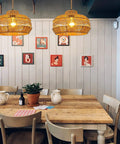 Hand Woven Rattan Pendant Light With Plug In Cord 15Ft Hemp Rope, On Off Switch over dining table with art decor walls.