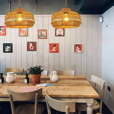 Hand Woven Rattan Pendant Light With Plug In Cord 15Ft Hemp Rope, On Off Switch over dining table with art decor walls.