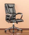 Office chair with black leather upholstery, padded back and seat, chrome armrests, five-wheel base on wood floor.
