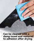 Cleaning a Non Slip Rug Corner Gripper from a pack of 8 with a damp towel to restore adhesion, showing reusable dual-sided adhesive.