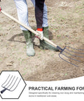 Person using Handheld Manure Fork For Home Gardening And Lawn Cleanup on dirt