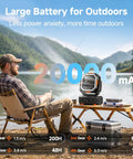 Man fishing by lake with Portable Camping Fan With 20000mAh Battery Remote And Led Lantern on table, mountains in background