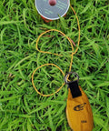 Throw Weight Pouch Set For Arborist Tree Climbing, 12 Oz, Luminous Yellow bag on grass with line spool