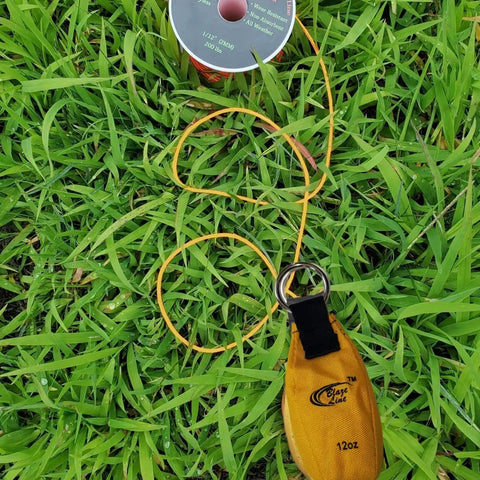 Throw Weight Pouch Set For Arborist Tree Climbing, 12 Oz, Luminous Yellow bag on grass with line spool