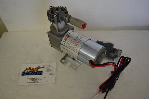 24V Onboard Air Rig For Trucks And SUVs With 120 PSI Max, 1.03 CFM, Nine Percent Duty Cycle, engine must be running, depicted resting on a table next to mounting hardware and cables.