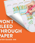 Hand using Go-To Felt Tip Pens Set With Flair Markers, Medium Point 0.7mm, showing no ink bleed on calendar page.