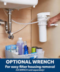 Under-sink view of Whole Home Water Filtration System With Install Kit Reduces Lead Asbestos Chlorine And More For Cleaner Taps One Stage Filter With Six Month Replacement Cycle Compatible With 9x2 Filters FXUTC FXULC FXUVC, with storage basket and optional wrench.