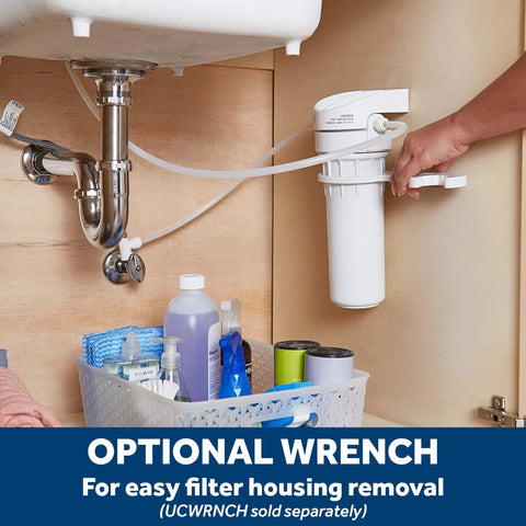 Under-sink view of Whole Home Water Filtration System With Install Kit Reduces Lead Asbestos Chlorine And More For Cleaner Taps One Stage Filter With Six Month Replacement Cycle Compatible With 9x2 Filters FXUTC FXULC FXUVC, with storage basket and optional wrench.